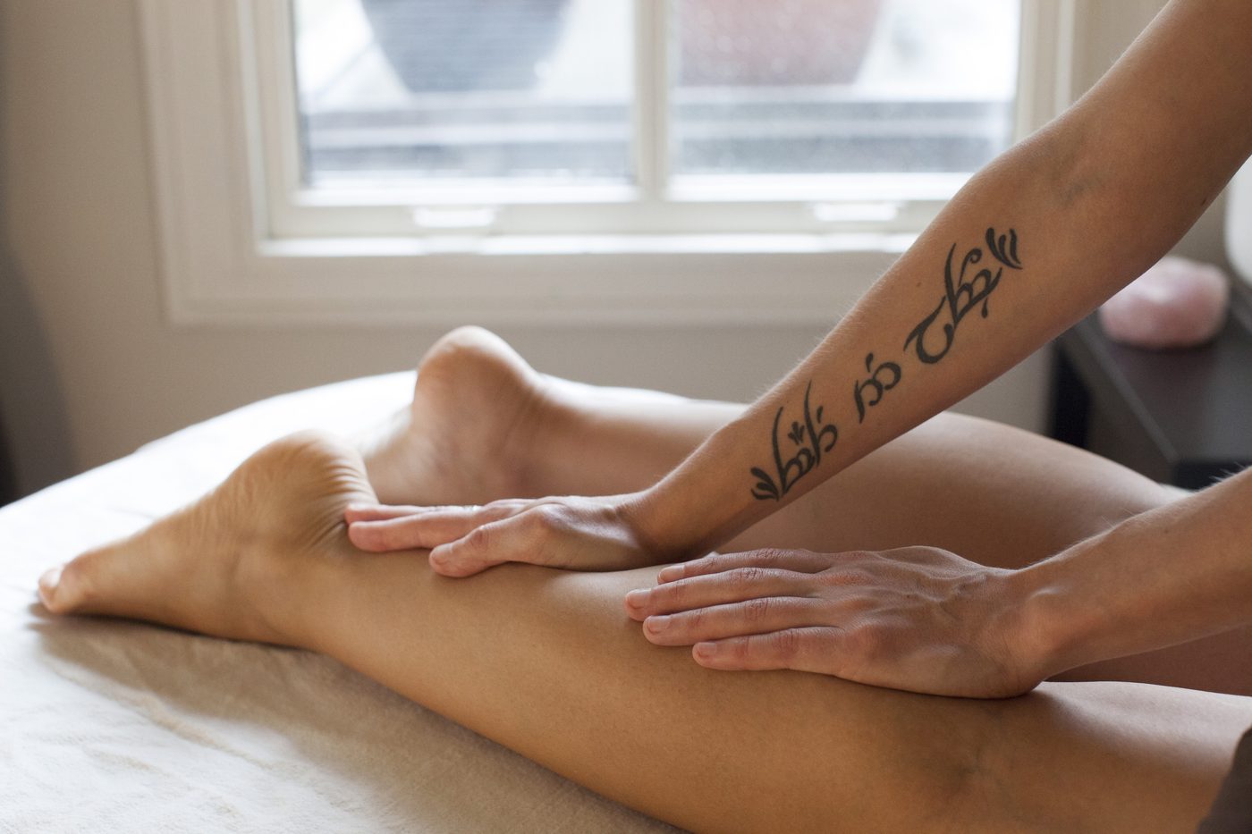Registered Massage Therapist treating a client's calf and leg at Cascade Massage Therapy, Vancouver