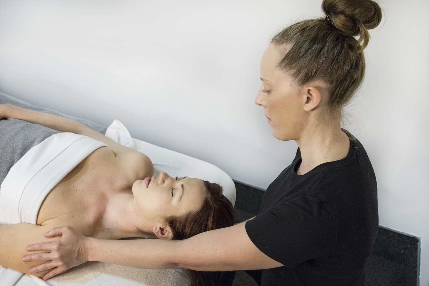 Registered Massage Therapist treating a client's neck and shoulders at Cascade Massage Therapy, Vancouver